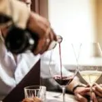 waiter pouring wine - Serrato's Steakhouse, Fine Dining in Franklin
