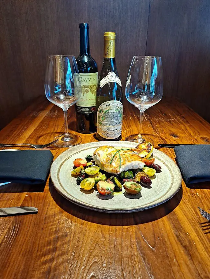 Panseared Grouper Roasted Sprouts Heirloom Tomatoes and Thyme Lemon Vinaigrette - Serrato's Steakhouse